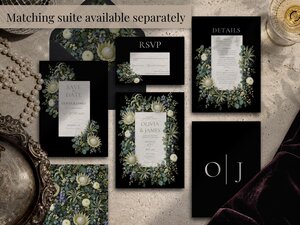 An arrangement of matching wedding stationery items including invitations, RSVP cards, and details cards is displayed on a textured surface.