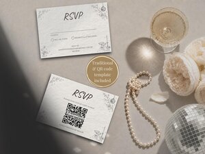 Two white textured RSVP cards with black text and line illustrations arranged on a surface next to a glass of champagne, pearls, and flowers.