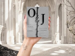 Minimal editorial gothic wedding invitation featuring sculptural black thorn motifs, elegant typography and monochrome styling on a soft neutral background.
