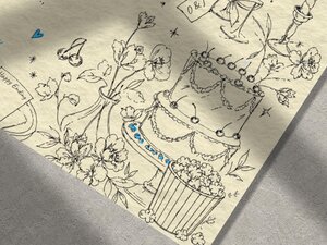 A close-up view of the illustrated wedding invitation showing detailed line art of a multi-tiered cake, flowers, and popcorn.