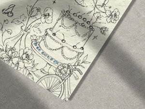 A close-up shot focuses on the lower right portion of the wedding invitation showcasing line art of a multi-tiered cake and flowers.