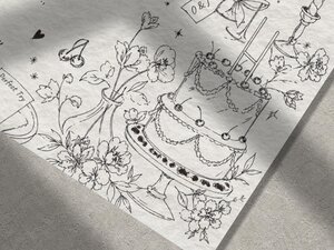 A close-up view of line-art illustrations on the wedding invitation showing a multi-tiered cake, flowers, and a rugby ball.