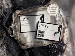 Two RSVP cards with snake graphics and RSVP text displayed on an ornate silver tray surrounded by black lace and pearls.
