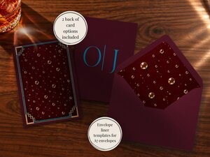 Stationery items including a burgundy card with bubble patterns, an envelope with a lined interior, and a card with blue monogram letters on a wooden table.