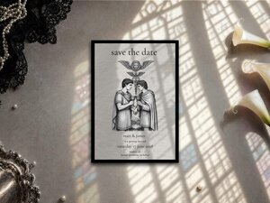The save-the-date card lies flat on a surface patterned with shadows from a window blind.