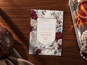 Football wedding invitation featuring claret and blue florals surrounding a traditional shield with a rampant lion crest and subtle soccer heritage details.