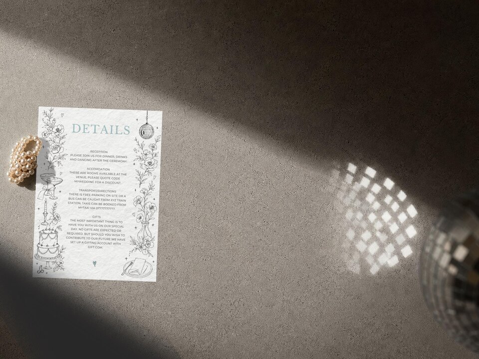 A details card with travel-themed line art is on a gray surface, with a disco ball and a champagne glass visible in the background.