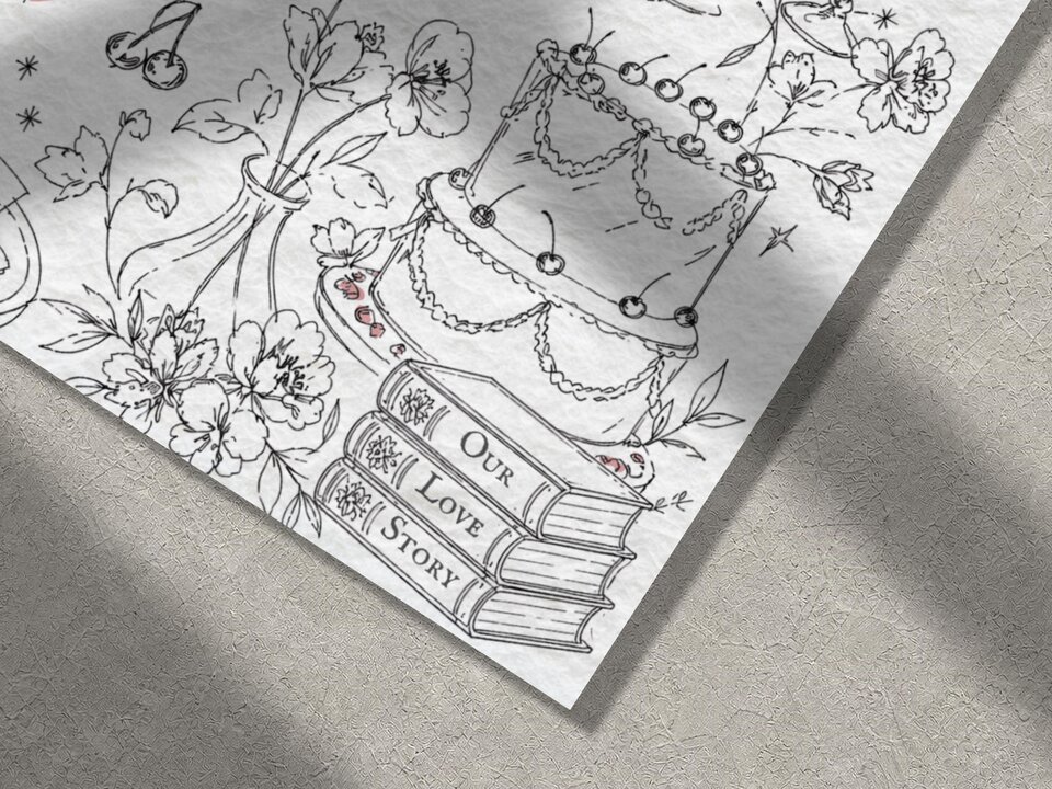 A close-up of the bottom right corner of a white invitation, showing black line-art illustrations of a cake with cherries, a stack of books labeled "Our Love Story," and floral elements.