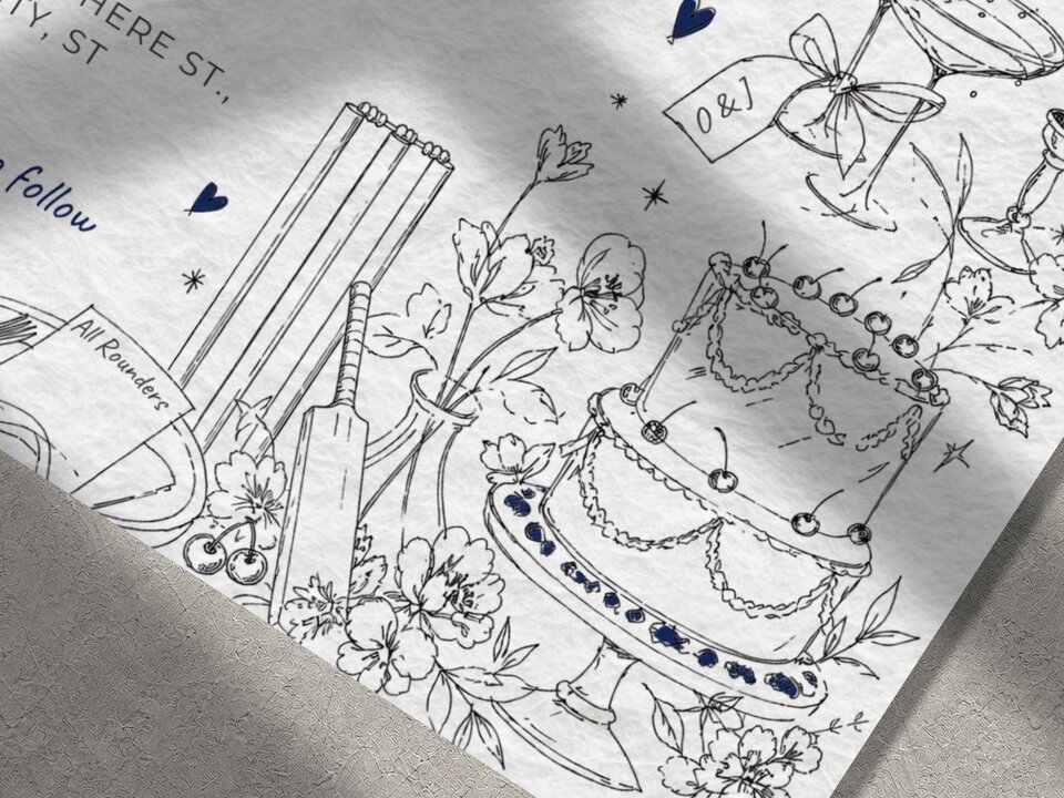 A close-up shot of the wedding invitation featuring sketched line art of a multi-tiered cake, cricket bat, and wicket stumps.