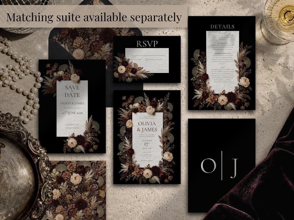 A flat lay showing a full stationery suite with save the date cards, RSVP cards, and details cards featuring dark floral designs.