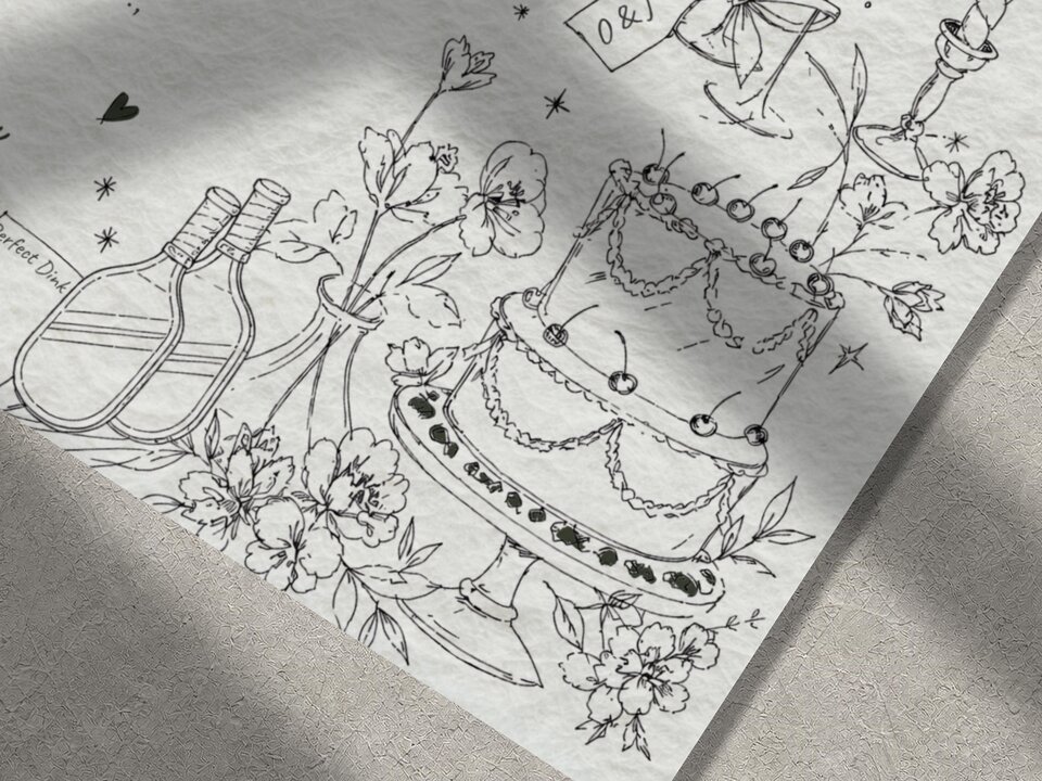 A close-up of the illustrated wedding invitation featuring line drawings of two pickleball paddles, flowers, a multi-tiered cake, and champagne glasses.