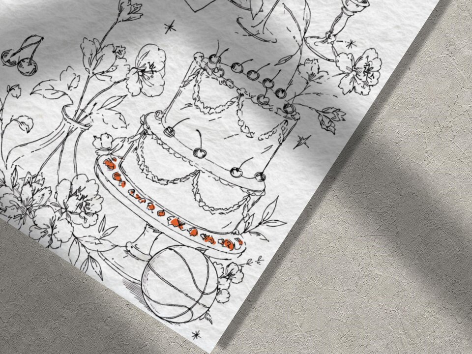 Close-up detail of the illustrated wedding invitation showing a multi-tiered cake, flowers, and a basketball sketch.