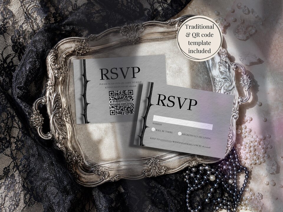 Two RSVP cards with thorny branch designs rest on an ornate silver tray next to black lace and pearl beads.