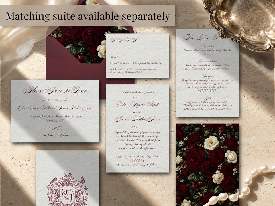 A collection of matching wedding stationery including an invitation, RSVP card, details card, and save-the-date card arranged on a textured surface.