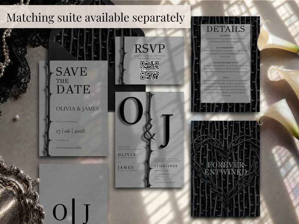 A flat lay collection of matching wedding stationery items featuring grey backgrounds and thorny vine accents.