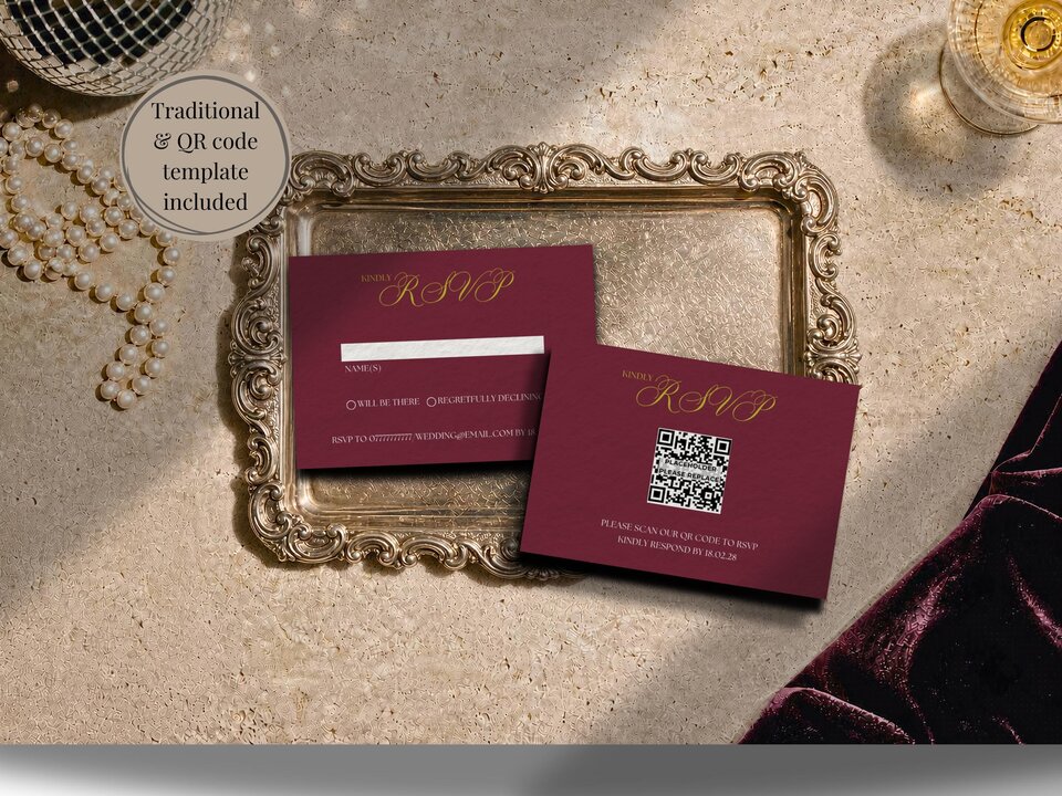 Two burgundy RSVP cards with gold text lie on an ornate gold tray next to a pearl necklace.