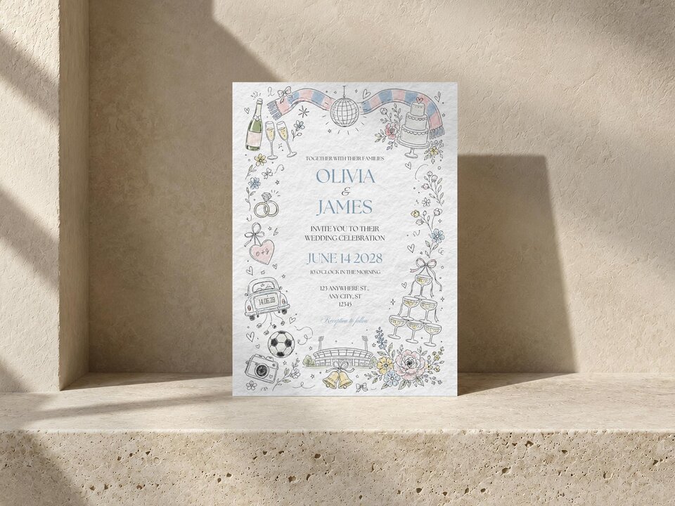 A wedding invitation card stands upright on a textured stone ledge against a beige wall.