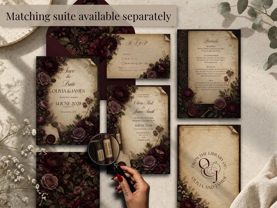 An arrangement of multiple vintage wedding stationery pieces including save the dates, RSVP cards, and details cards with dark floral motifs.