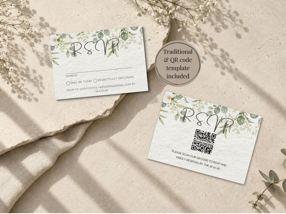Two RSVP cards with floral borders and a QR code option are displayed on a beige stone and fabric surface.