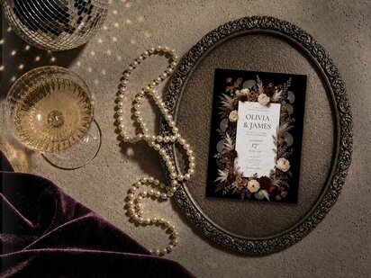 editorial gothic brown chocolate mocha floral invite with black background.  Ivory roses, burgundy dahlias, dried pampas grass, ferns and ginkgo leaves in warm autumnal tones